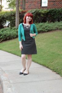 pearl necklace and green blazer